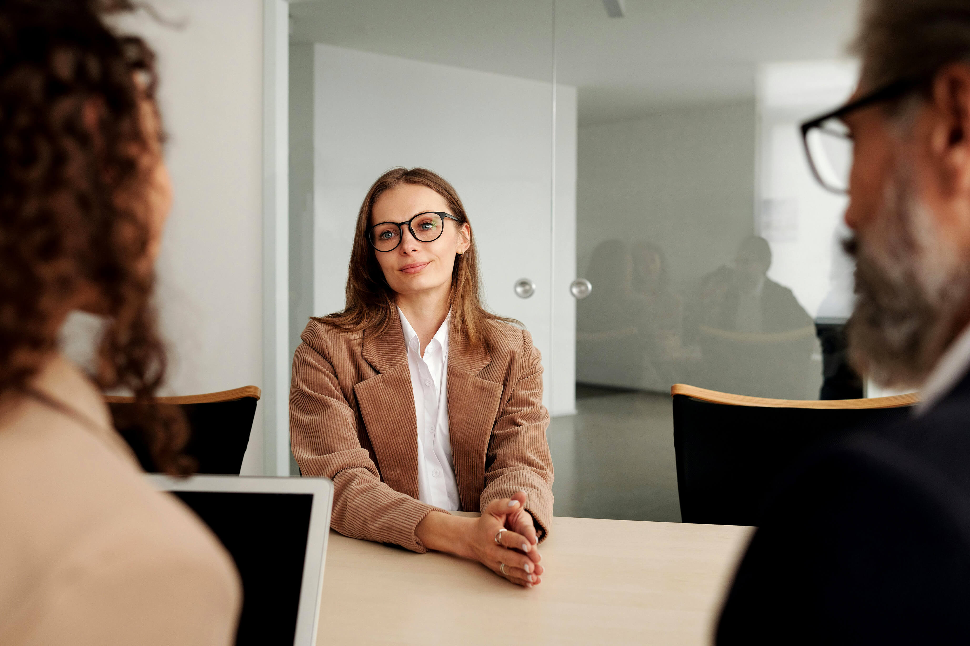 A woman being interviewed by two people