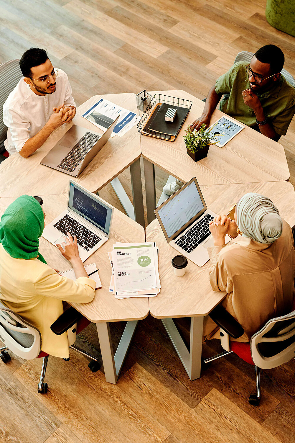 Four people around a table having a discussion